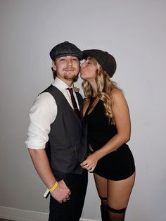 a man and woman dressed in black posing for the camera