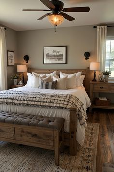 a bedroom with a bed, dresser and ceiling fan