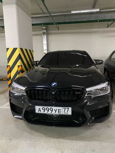 two cars parked in a parking garage next to each other