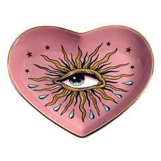 a pink heart shaped plate with an eye on the center and stars in the middle