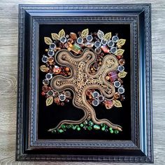 a framed artwork depicting an intricate tree with many different things on it's branches