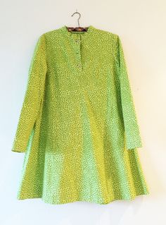 "This is a wonderful long sleeved shirt dress, custom made in fabric from Finnish company Marimekko. All the details are the same as a Marimekko made dress, the buttons, the style etc. Lime gren with green dots. Very happy and bright. A-line babydoll model. Would fit Mumin character Lilla My :-) 100% cotton. Fits a X Small to Small. Very good condition, looks like it's never been used. Pit-pit: 90cm / 35,5\" Length: 82cm / 32\" (but can be made longer) Arm length: 56cm / 22\" Don't hesitate to a Green Fitted Kurta With Stand Collar, Long Sleeve Dresses With Button Closure, Fitted Cotton Dress With Button Cuffs, Long Sleeve Cotton Dresses With Covered Buttons, Fitted Cotton Dresses With Button Cuffs, Green Long Sleeve Shirt Dress For Daywear, Green Long Sleeve Shirt Dress With Button Closure, Mod Long Sleeve Dresses, Green Long Sleeve Kurta For Spring