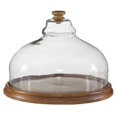 a wooden base under a glass dome on top of a tray with wood trimmings