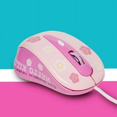 a pink hello kitty mouse sitting on top of a pink and blue striped surface with the word hello kitty printed on it