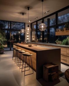 an image of a modern kitchen setting with lights on the ceiling and bar stools