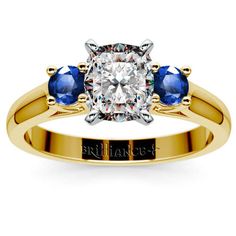 A classic center diamond cut paired with two sparkling round sapphires brings a whole new meaning to Forever... Propose to your sweetheart with the Cushion Round Sapphire Gemstone Ring in gorgeous Yellow Gold! http://www.brilliance.com/engagement-rings/round-sapphire-gemstone-ring-yellow-gold Gia Certified Gold Sapphire Ring In 14k Gold, Gia Certified Gold Diamond Promise Ring, Gia Certified Gold Diamond Ring, Gold Diamond Ring With Sapphire Center Stone, Yellow Gold Three-stone Sapphire Ring, Yellow Gold Gia Certified Diamond Promise Ring, Yellow Gold Three Stone Sapphire Ring, Yellow Gold Sapphire Diamond Ring With Center Stone, Gia Certified Yellow Gold Diamond Promise Ring