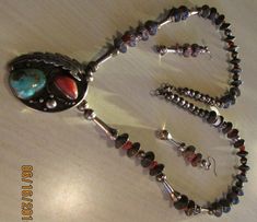 "Beautiful sterling silver coral and turquoise Navajo necklace. Not signed. The pendant is 1 7/8\" tall x 1 3/8\" wide. The necklace is 28\" of sterling silver hogan and bench made beads and coral beads. There are also some squash blossom like beads. All have natural patina and are in good condition. There are matching 2 1/8\" beaded earrings which hang from silver hooks or wires. Shipped by US first class mail and insured. BDS-1" Southwestern Silver Turquoise Multi-stone Necklace, Silver Southwestern Multi-stone Turquoise Necklace, Navajo Necklace, Squash Blossom, Necklace And Earring Set, Coral Beads, Tucson, Beaded Earrings, Earring Set