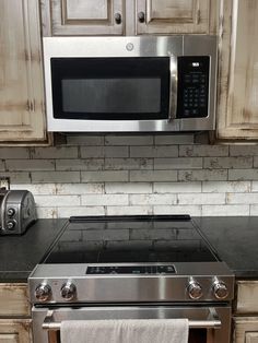 a stainless steel oven and microwave in a kitchen