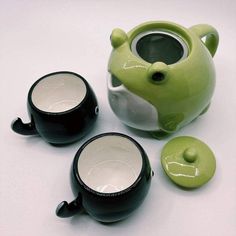 three green and white teapots sitting next to each other