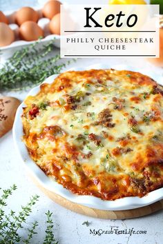 keto cheese steak quiche on a plate with fresh herbs and eggs in the background