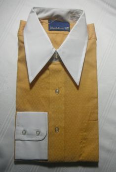 Vintage golden yellow shirt, white collar & cuffs, 65% Dacron Polyester & 35% Combed Cotton, never worn, in original package, never opened. Collar 15.5in. sleeves 33in. Yellow Formal Shirt For Spring, Formal Yellow Shirt For Spring, Spring Formal Yellow Shirt, Classic Gold Shirt For Formal Occasions, Yellow Collared Shirt For Work, Gold Formal Shirt For Spring, Gold Formal Shirt For Summer, Summer Formal Gold Shirt, Elegant Yellow Formal Tops