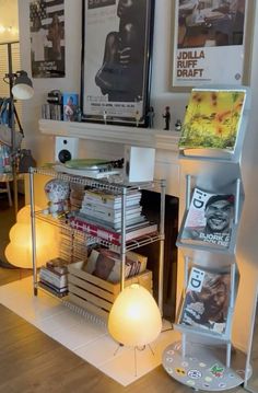 a living room filled with lots of furniture and books on top of a wooden floor