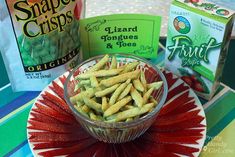 some food is sitting in a bowl on a table next to two bags of chips