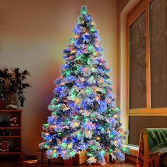 a brightly lit christmas tree in a living room