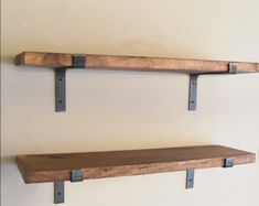 two wooden shelves with metal brackets on them