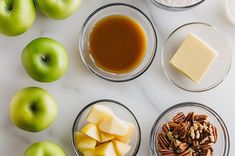 apples, walnuts, butter, and other ingredients are arranged on a white surface