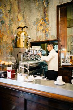 a man standing in front of a counter filled with food