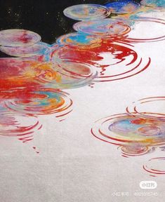 an abstract painting with red, white and blue circles in the water on a black background