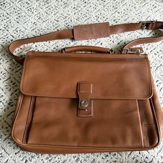 Never Used. With Tags. A Few Leather Scratches Seen In Pictures. Silver Hardware. Big Enough For Laptop. Timeless Brown Satchel With Adjustable Strap, Classic Brown Briefcase For Travel, Classic Brown Briefcase With Adjustable Strap, Classic Brown Briefcase For Everyday Use, Classic Brown Everyday Briefcase, Classic Dark Tan Shoulder Bag With Adjustable Strap, Classic Dark Tan Shoulder Bag, Coach Everyday Rectangular Briefcase, Designer Brown Tote Briefcase