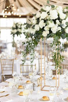 the centerpieces are filled with white flowers and greenery