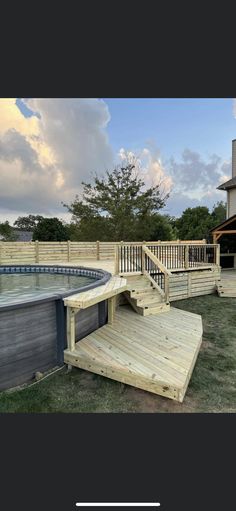 an above ground pool with steps leading up to it and a deck in the background