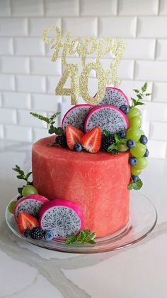 a cake decorated with fruit and the number twenty four on top is sitting on a plate