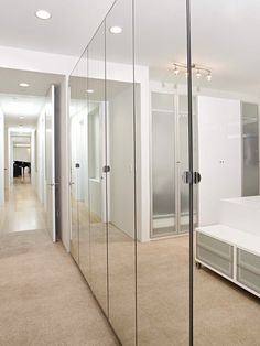 an empty bedroom with white walls and beige carpeted flooring is seen in this image