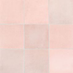 a pink tiled wall with white squares on it