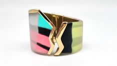 "Lucite Cuff Bracelet, Colorful Bangle Bracelet, Stained Glass Bracelet, Asymmetrical Bracelet, Graffiti Jewelry, Punk Cuff, Alexis Bittar Measurements: Fits up to 7.25\"L wrist. Width at widest point is 2\"W, at smallest point 1.5\"W Metal: Gold Tone Findings: Hinged Finish: Polished Excellent Condition You know that expression 'Party in the front, business in the back?' Yeah, this isn't that. This GORGEOUSLY UNIQUE piece from world famous jewelry designer Alexis Bittar is 100% PARTY ALL THE WAY AROUND! With a color scheme inspired by the wonderful 1980s this bright, colorful and happy piece will have you smiling all day long! Colors of Lucite include blue, pink, pale yellow, white and black, all of which have a STUNNING metallic sheen painted over the top. The front of the cuff features Modern Multicolor Cuff Bangle Bracelet, Modern Multicolor Bangle Cuff Bracelet, Modern Adjustable Multicolor Cuff Bracelet, Handmade Modern Party Bangle, Modern Handmade Party Bangle, Trendy Multicolor Party Bangle, Modern Cuff Bracelet Bangle As Fashion Accessory, Modern Green Cuff Bangle Bracelet, Multicolor Bangle Cuff Bracelet For Party