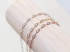 Our Small Paperclip chain has elongated links measuring 2.25 x 5mm in 14k gold filled, sterling silver and rose gold filled metals. Our favorite laying combo is a the Paperclip as a texture, then add a straight line chain like the Curb Chain. Lengths Bracelets: 6", 7", 8" with a .5" adjustable ending Anklets: 7", 8", 9", 10" with a 1" adjustable ending Necklaces:: 14", 16", 18" with a 1.5" adjustable ending Packaged in our logo stamped gift boxes, ready for gift giving. Layering chains are cut f Rose Gold Oval Link Chain Necklace As Gift, Rose Gold Oval Link Chain Necklace, Rose Gold Chain Necklace With Delicate Rectangular Links, Dainty Gold-tone Paperclip Chain Jewelry, Rose Gold Rolo Chain Link Necklace, Rose Gold Chain Necklace With Rectangular Links, Adjustable 14k Gold-filled Paperclip Bracelet With Delicate Chain, Rose Gold Paperclip Chain Necklace, Gold Plated, Elegant 14k Gold-filled Paperclip Bracelet With Adjustable Chain