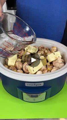 someone is pouring water into a bowl filled with nuts and other things to make it look like they are eating something