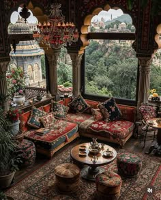 a living room filled with lots of furniture next to a large window covered in chandelier