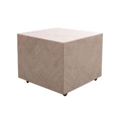 a cube shaped table with wheels on the bottom and an angled surface, in beige marble