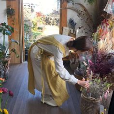 a woman arranging flowers in a flower shop