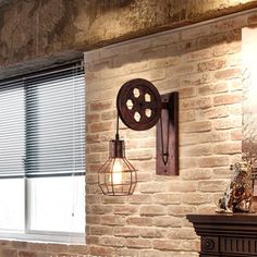 a brick wall with a light fixture on it next to a window and a fireplace