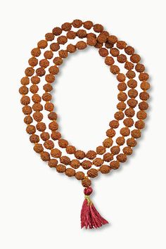 This simple hand-crafted mala featuring a deep red tassel, is made of 108 knotted Rudraksha seed beads and is perfect for your everyday ritual and mediation. Legend has it that the first Rudraksha seeds were created from tears of Lord Shiva as they fell on the earth and formed into a tree. Rudraksha seeds have wonderful spiritual and medicinal properties and, you can feel their power as you count through the beads one by one to recite your chosen mantra or intention. The number 108 holds spiritu Spiritual 108 Beads Mala For Yoga, Holistic Hand-strung Mala For Meditation, Spiritual Mala With Round Beads For Yoga, Hand-strung Spiritual Mala For Meditation, Spiritual Mala For Yoga With Round Beads, Spiritual Yoga Mala With Round Beads, Spiritual Mala With 8mm Beads For Rituals, Holistic Wooden Beads Mala For Rituals, Spiritual Hand-strung Mala For Meditation