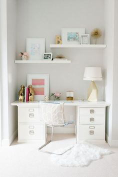 an image of a room with white furniture and pictures on the wall, including bookshelves