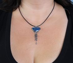 This necklace features a stone called shattuckite, which is from Arizona. It has gorgeous blue color with some pretty veining of black which is outlined in a lighter blue color. Really beautiful stone and the extra bit of dangle make it a really fun flirty piece. Pendant is just 1 1/4 inches long and with the chain tassel 2 3/4 inches ♦Chain: This comes either on a very nicely weighted silver cable chain or leather cord and you can choose your preference when you add to cart. The silver chain ha Blue Chrysocolla Necklace With Stones, Blue Chrysocolla Necklace With Large Stone, Blue Sodalite Pendant Necklace, Artisan Blue Necklace With Large Stone, Blue Chrysocolla Pendant Necklace, Blue Chrysocolla Pendant Jewelry, Blue Chrysocolla Jewelry With Large Stone, Blue Agate Cabochon Jewelry, Iolite Necklace