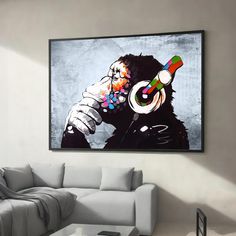 a living room with a couch and painting on the wall