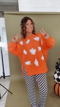 Upgrade your spooky season look with our BOO Thing Oversized Halloween Ghost Sweatshirt - This terry cloth oversized sweatshirt will keep you warm and stylish all fall long! Featuring sequin ghosts throughout this sweatshirt created the perfect spooky season look!! Sequin ghost sweatshirt Orange Oversized halloween sweatshirt Spooky season sweatshirt Terry cloth material Measurements: (Approximate. Measured lying flat.**Oversized fit. Size down for a less oversized fit. ) S- (4/6) Length 26 1/4" M- (8/10) Length 27" L- (12/14) Length 27 1/2" Model Specs: Emily is wearing a size small in the photo.How will this item fit you? Check out our MODEL SPECS (Typical Sizing - Karli: S-Size 5/26 - 5ft 2in, Emily: S-Size 3/25 - 5ft 5in, Syd: L/XL- Size 15/ - 5ft 8in)Need help with sizing? No problem! Oversized Spooky Tops For Halloween, Oversized White Halloween Sweater, Oversized Halloween Sweatshirt For Loungewear, Spooky Long Sleeve Sweatshirt For Fall, Spooky Orange Crew Neck Top, Halloween Long Sleeve Loungewear Sweatshirt, Oversized Spooky Sweatshirt For Fall, Orange Halloween Sweatshirt, Spooky Oversized Halloween Sweatshirt