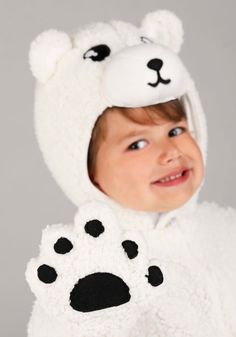 a young child wearing a bear costume