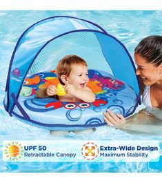 a woman is playing with a baby in the pool while another child swims inside