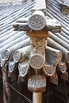 the roof is made of wood and has carvings on it