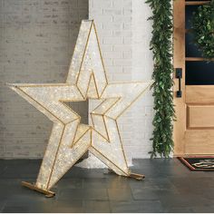 a large lighted star next to a door