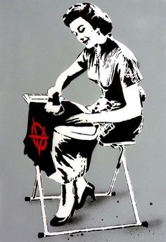 a woman is sitting on a folding chair with her legs crossed and holding an ironing board