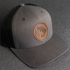 Wear your new Leather Patch Trucker Style Hat out fishing or anywhere! All hats ship for free within the USA! SPECS *Leather Patch Color Options: Natural Dublin, Nut Brown Dublin, or Cafe Chromexcel *Hat Color Options: Choose from Navy/White, Charcoal, or Green/Khaki *All of our products are made to order by hand in McKinney, TX MATERIALS *REAL HORWEEN LEATHER: Premium Full-Grain Leather. oEach patch is one-of-a-kind and made from part of a whole hide of leather. There will be unique variation f Black Curved Brim Fishing Hat, Black Curved Brim Hat For Fishing, Adjustable Black Fishing Hat, Adjustable Black Hat For Fishing, Adjustable Black Trucker Hat For Fishing, Adjustable Curved Brim Trucker Hat For Fishing, Outdoor Brimmed Trucker Hat, Adjustable Curved Brim Baseball Cap For Fishing, Brown Trucker Hat With Short Brim For Outdoor Activities