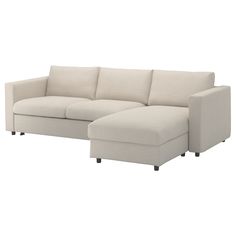 a white couch with a chaise lounge on it's legs and an ottoman