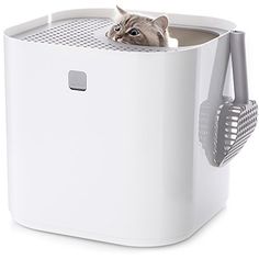 a cat peeks its head out from the top of a white box with mesh handles