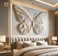 a bedroom with a large white butterfly on the wall above the headboard and pillows