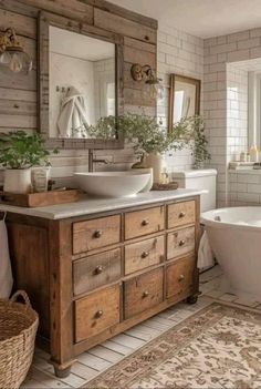 a bathroom with two sinks, a tub and a large mirror on the wall above it